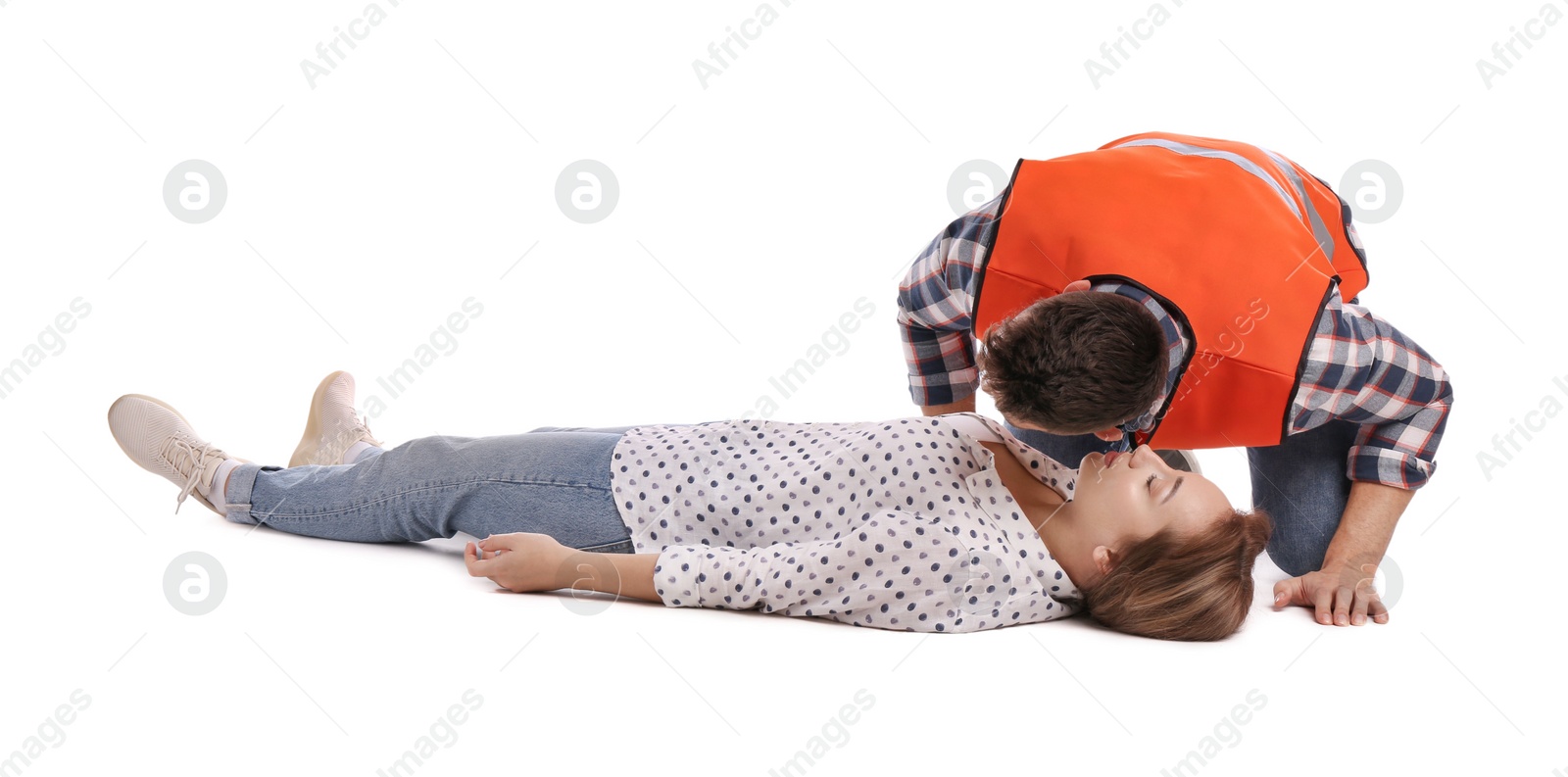 Photo of Paramedic in uniform performing first aid on unconscious woman against white background