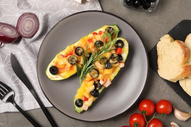 Photo of Flat lay composition with baked stuffed zucchinis served on grey table