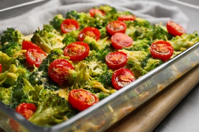 Photo of Tasty broccoli casserole in baking dish on table, closeup