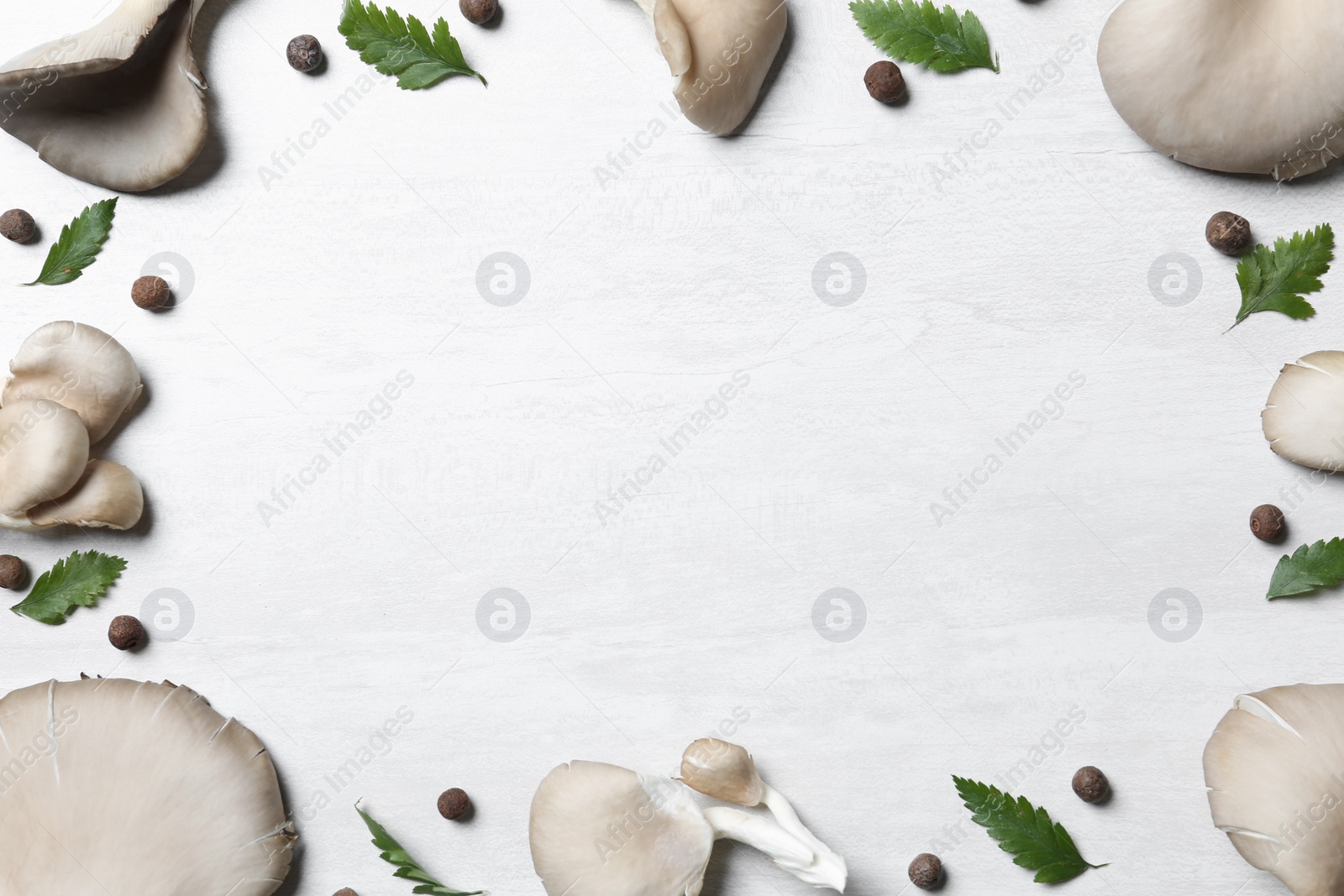 Photo of Frame made of organic oyster mushrooms and leaves on light background, flat lay with space for text