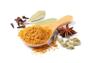 Photo of Spoon with dry curry powder and other spices isolated on white