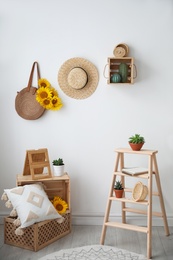 Photo of Bag with bouquet of beautiful sunflowers in stylish room interior