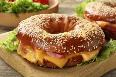 Photo of Delicious bagels with ham and cheese on table, closeup