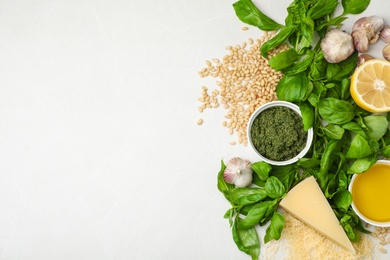 Flat lay composition with products and space for text on white background. Basil pesto sauce recipe