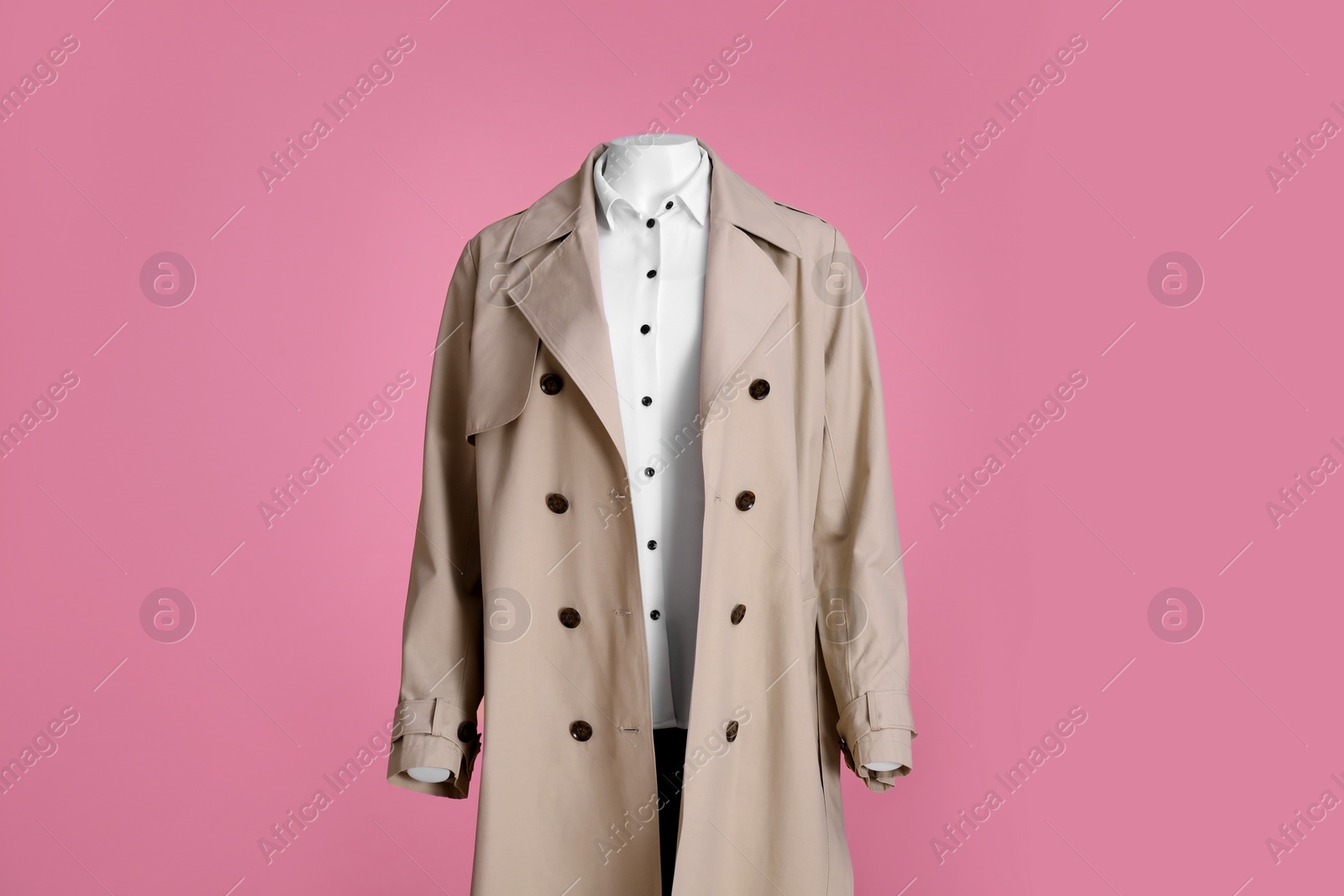 Photo of Female mannequin dressed in stylish stretch coat and shirt on pink background