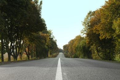 Photo of Beautiful view of empty asphalt highway and autumn trees