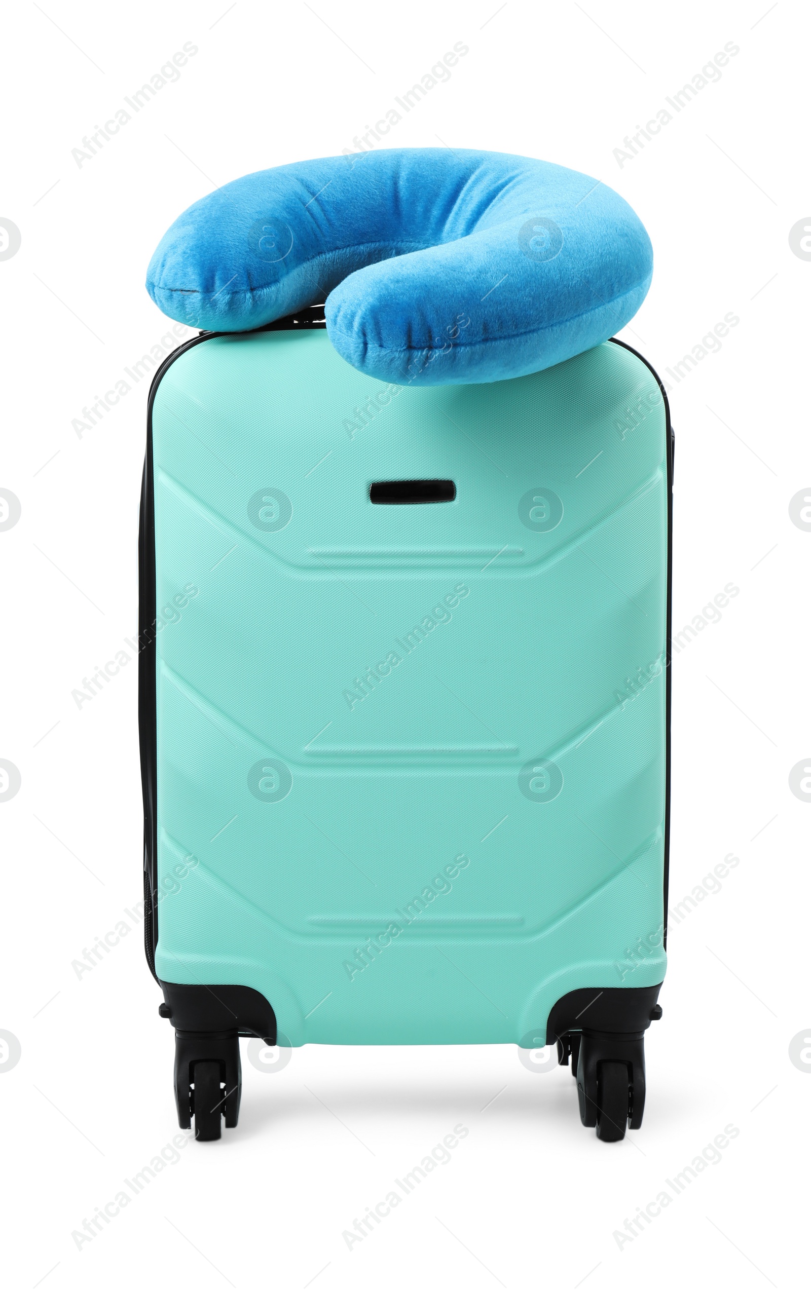 Photo of Soft travel pillow on turquoise suitcase isolated on white