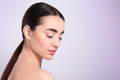 Photo of Beautiful woman with perfect eyebrows on light background