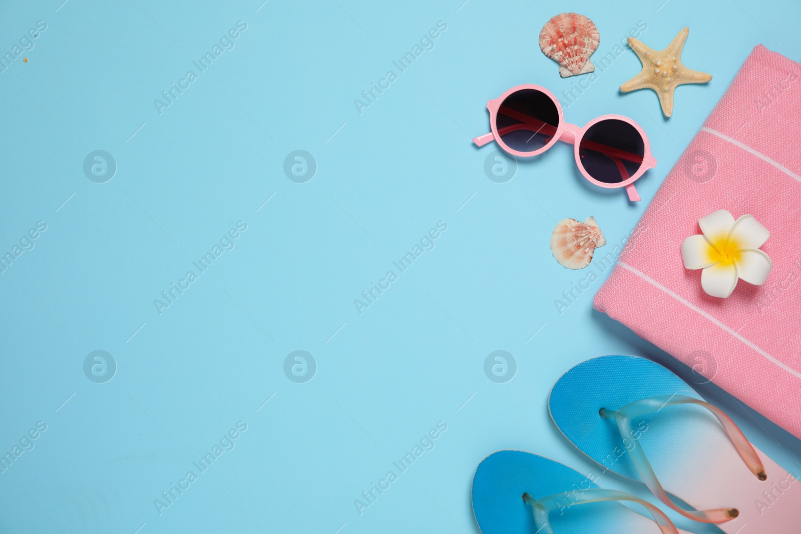 Photo of Flat lay composition with beach accessories on color background, space for text