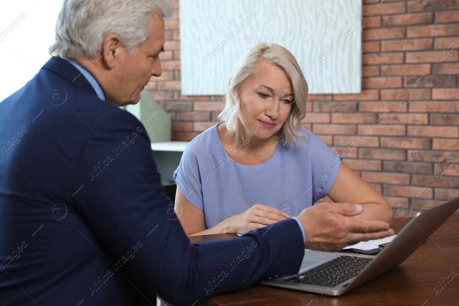 Photo of Senior notary working with client in office