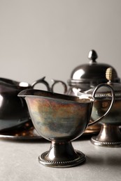 Photo of Beautiful tea set on grey textured table, closeup