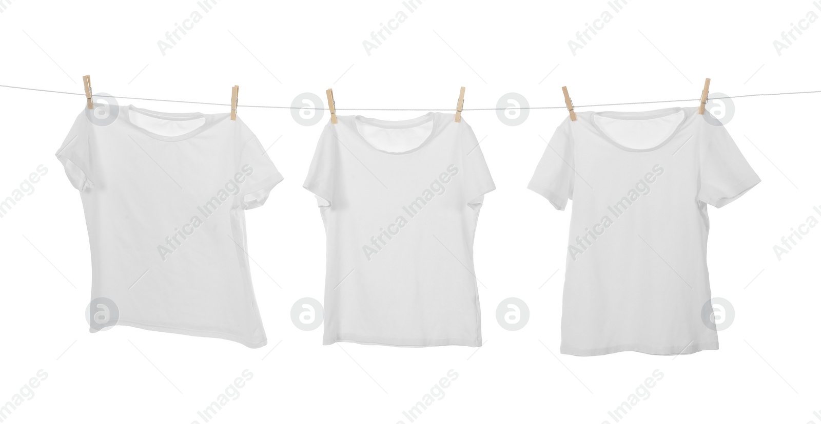 Photo of Many t-shirts drying on washing line isolated on white