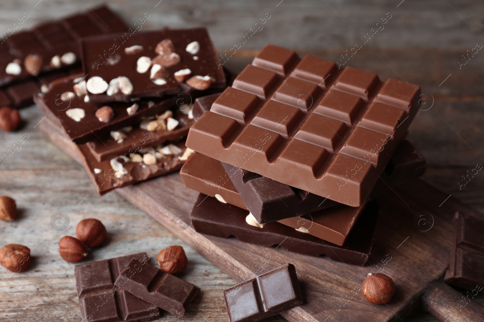 Photo of Different delicious milk and dark chocolate bars on table