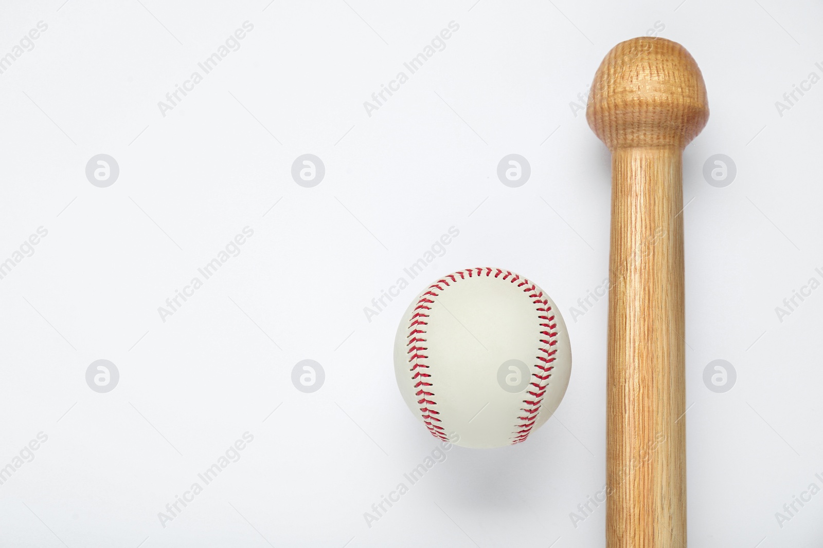 Photo of Wooden baseball bat and ball on white background, top view with space for text. Sports equipment