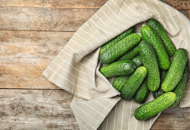 Photo of Ripe fresh cucumbers on wooden table, top view