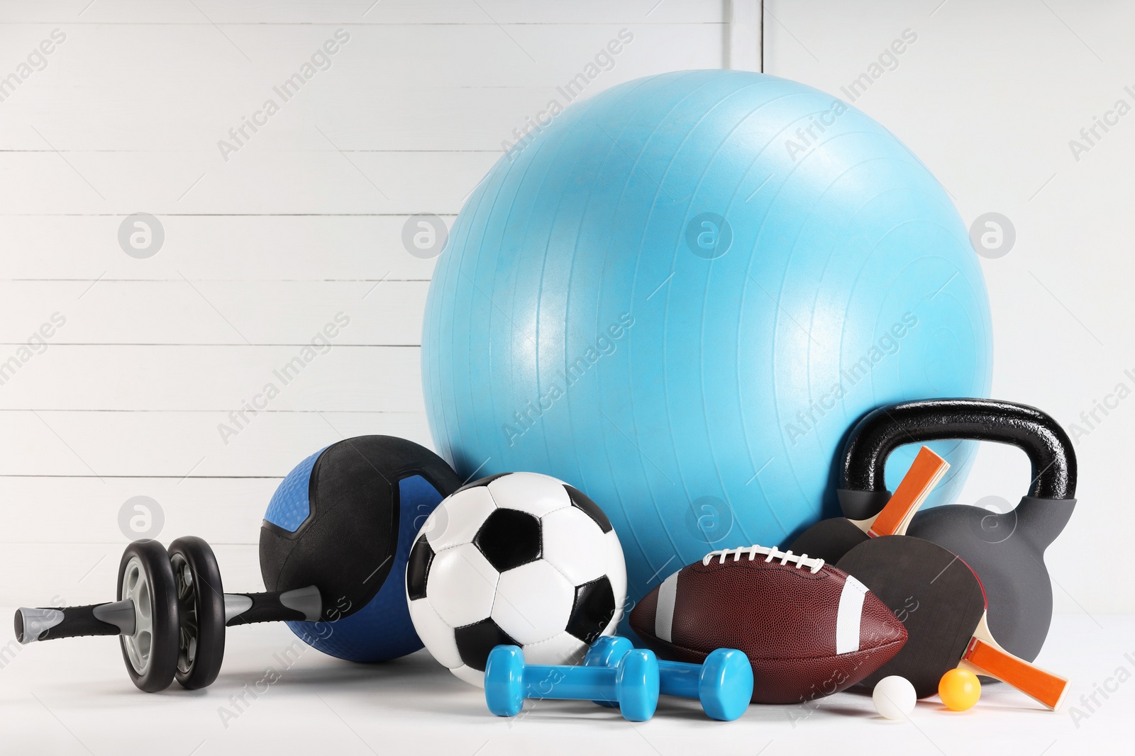 Photo of Many different sports equipment on white table