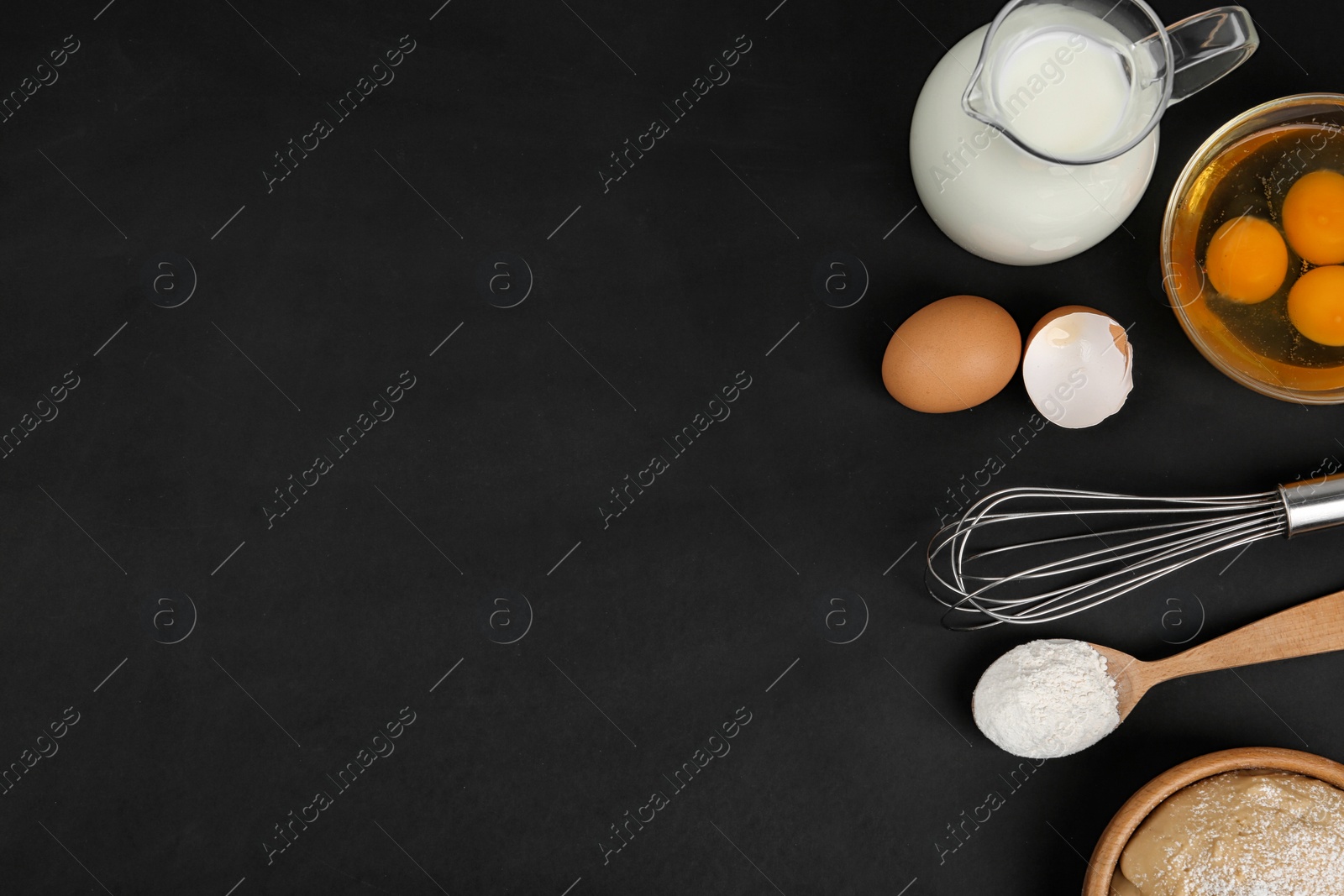 Photo of Flat lay composition with raw eggs and other ingredients on black background, space for text. Baking pie