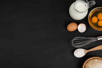 Photo of Flat lay composition with raw eggs and other ingredients on black background, space for text. Baking pie