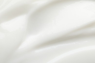 Photo of Texture of face cream as background, closeup view