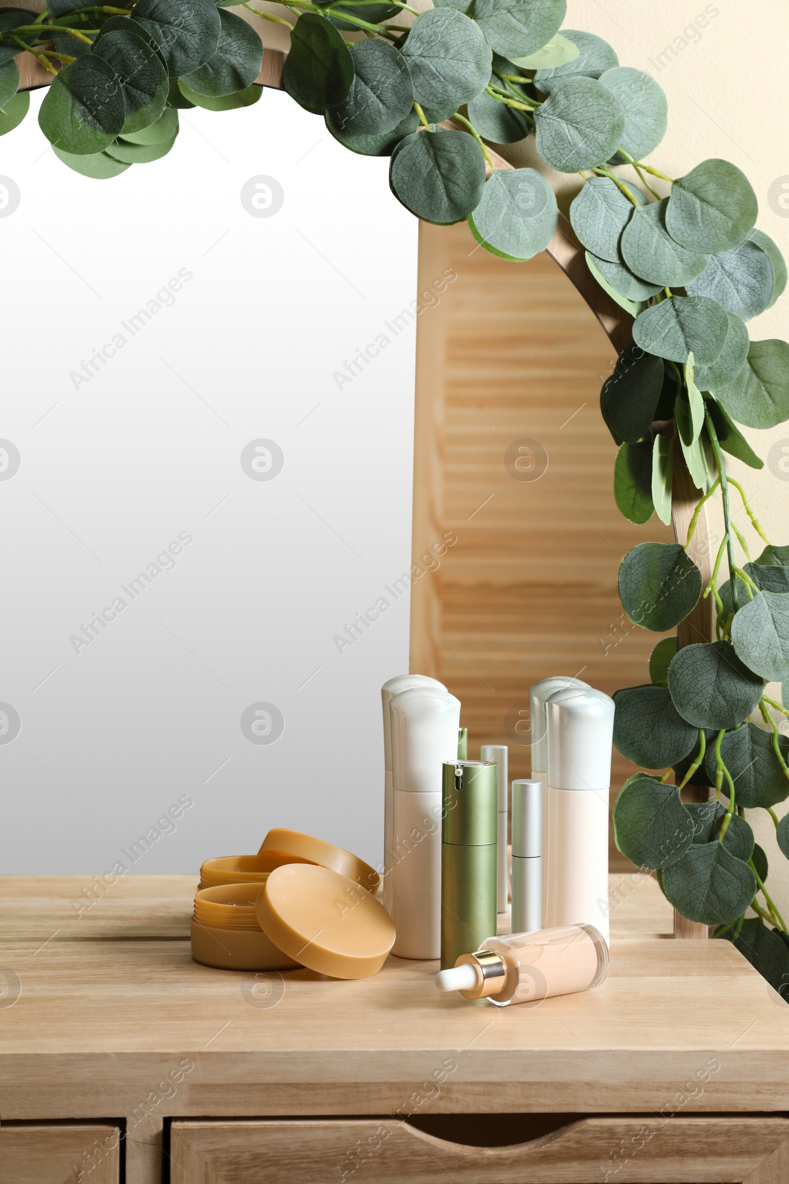 Photo of Dressing table with stylish mirror and cosmetic products