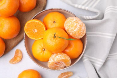 Fresh juicy tangerines on light grey table, flat lay