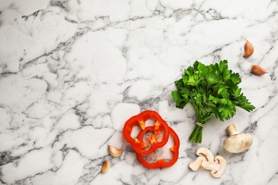 Photo of Flat lay composition with fresh parsley, garlic, mushrooms and paprika on marble background