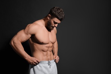 Photo of Handsome muscular man on black background, space for text. Sexy body
