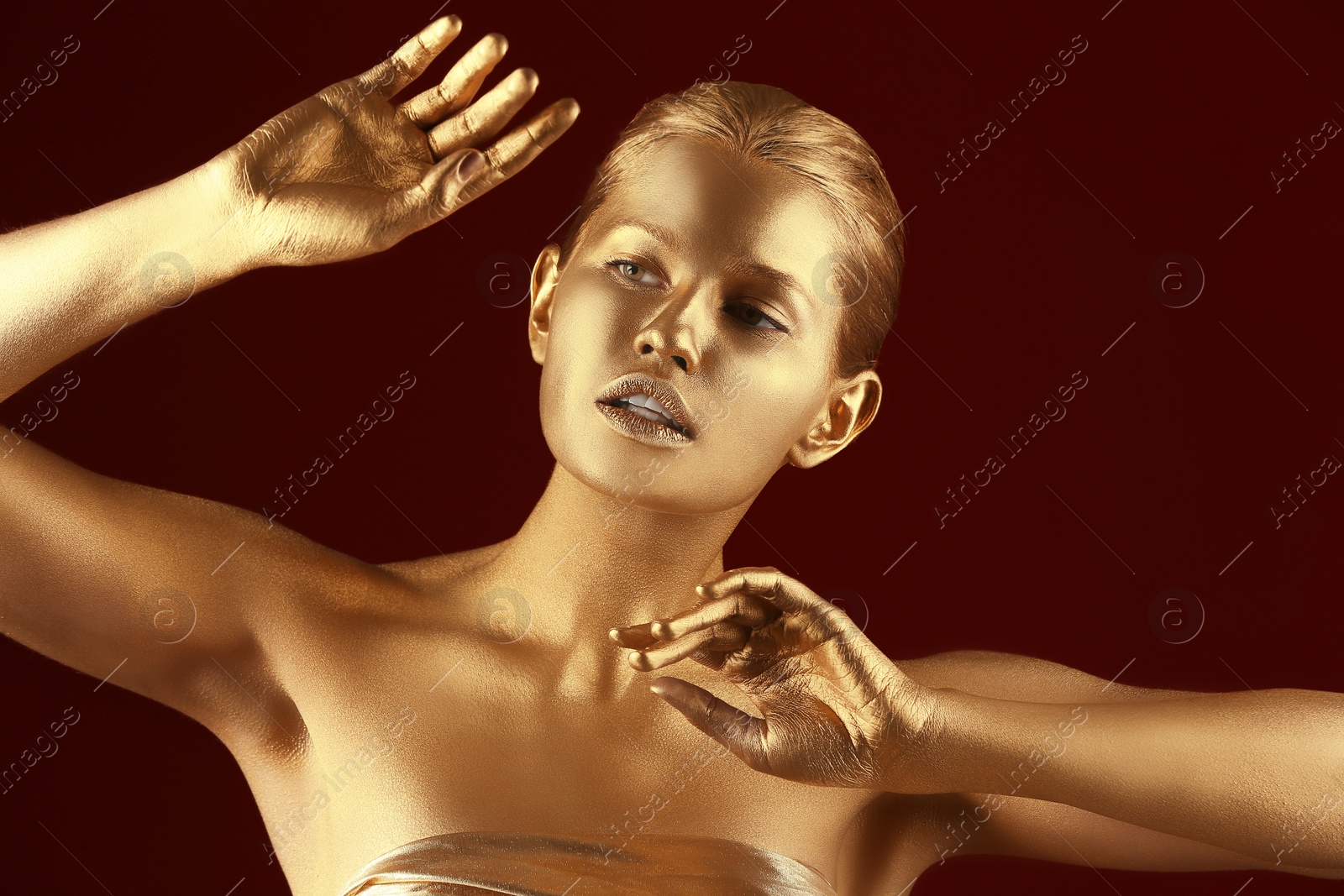 Photo of Portrait of beautiful lady with gold paint on skin against color background