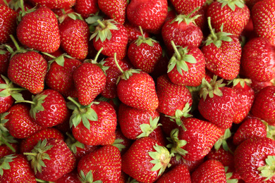 Photo of Tasty ripe strawberries as background, top view