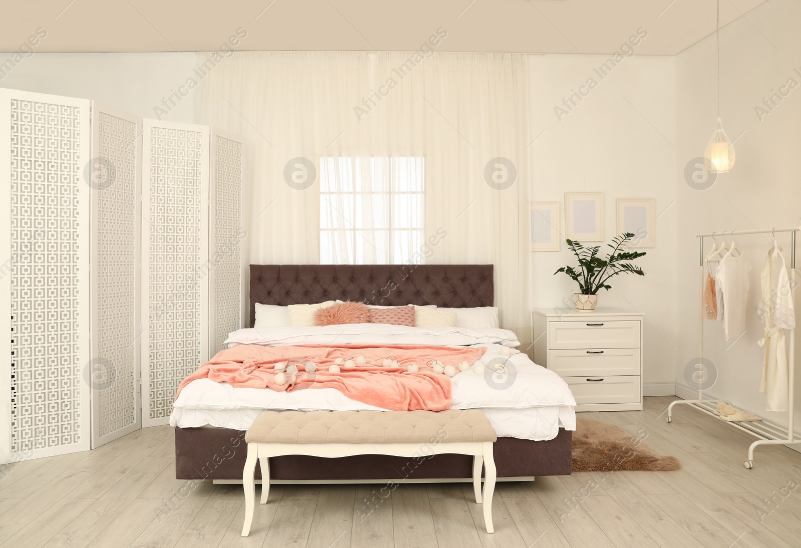 Photo of Modern folding screen in stylish bedroom interior