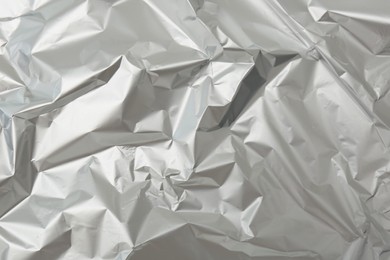 Photo of Crumpled silver foil as background, top view