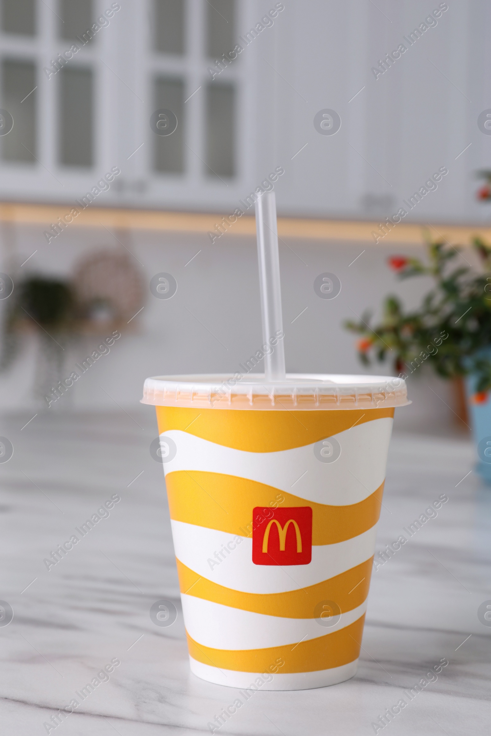 Photo of MYKOLAIV, UKRAINE - AUGUST 12, 2021: Cold McDonald's drink on marble table in kitchen