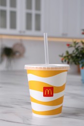 MYKOLAIV, UKRAINE - AUGUST 12, 2021: Cold McDonald's drink on marble table in kitchen