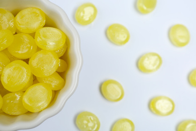 Photo of Flat lay composition with tasty lemon drops on white background