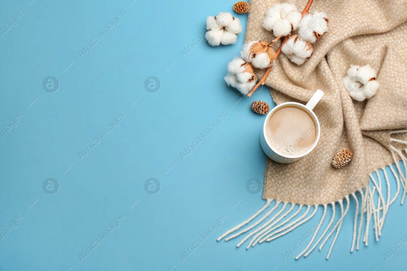 Photo of Flat lay composition with coffee and warm plaid on light blue background, space for text