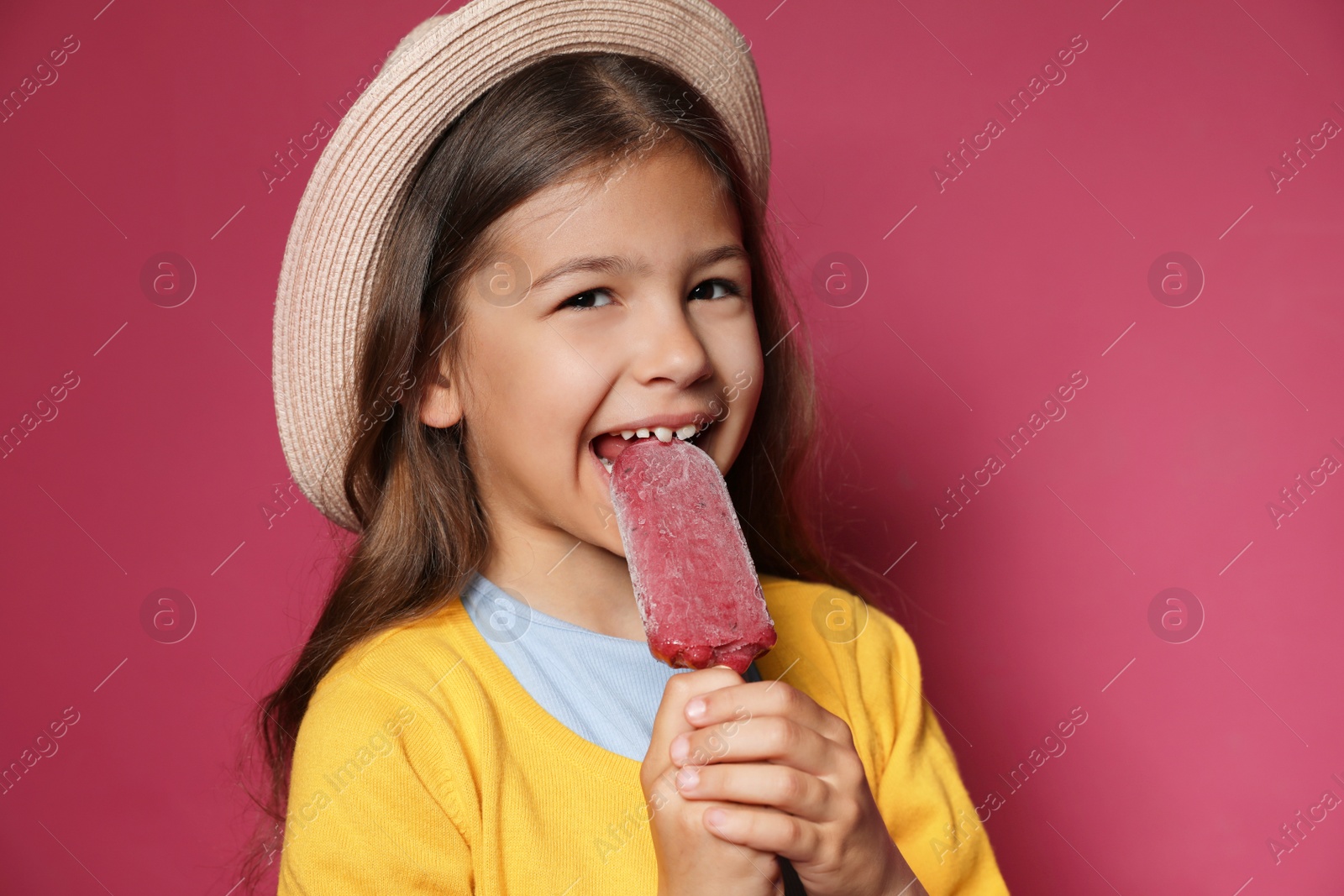 Photo of Adorable little girl with delicious ice cream against color background