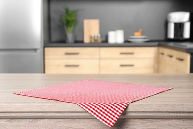 Photo of Napkin on wooden table in kitchen. Mockup for design