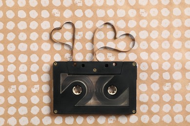 Photo of Music cassette and hearts made with tape on color background, top view. Listening love song