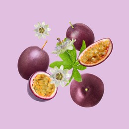 Tasty passion fruits, passiflora leaf and flowers falling on pink background