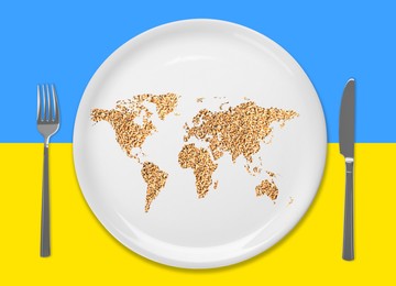 Image of Global food crisis concept. World map made of wheat grains in plate and cutlery on background in colors of Ukrainian flag, flat lay