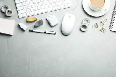 Photo of Flat lay composition with wired computer mouse and stationery on light grey table. Space for text