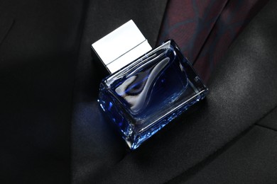 Luxury men's perfume in bottle on black jacket