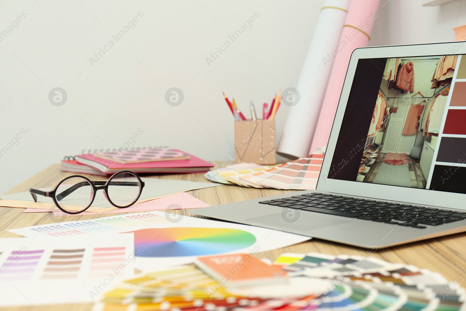 Photo of Designer's workplace with modern laptop and color palettes 