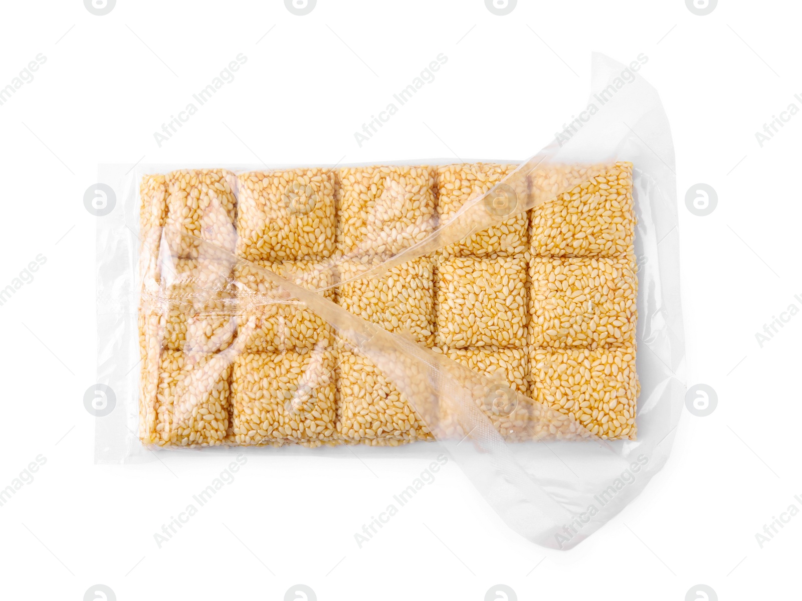 Photo of Unwrapped delicious sesame kozinaki bar isolated on white, top view