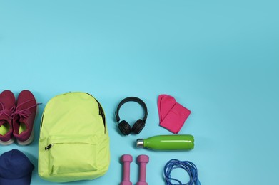 Photo of Different sports equipment on light blue background, flat lay