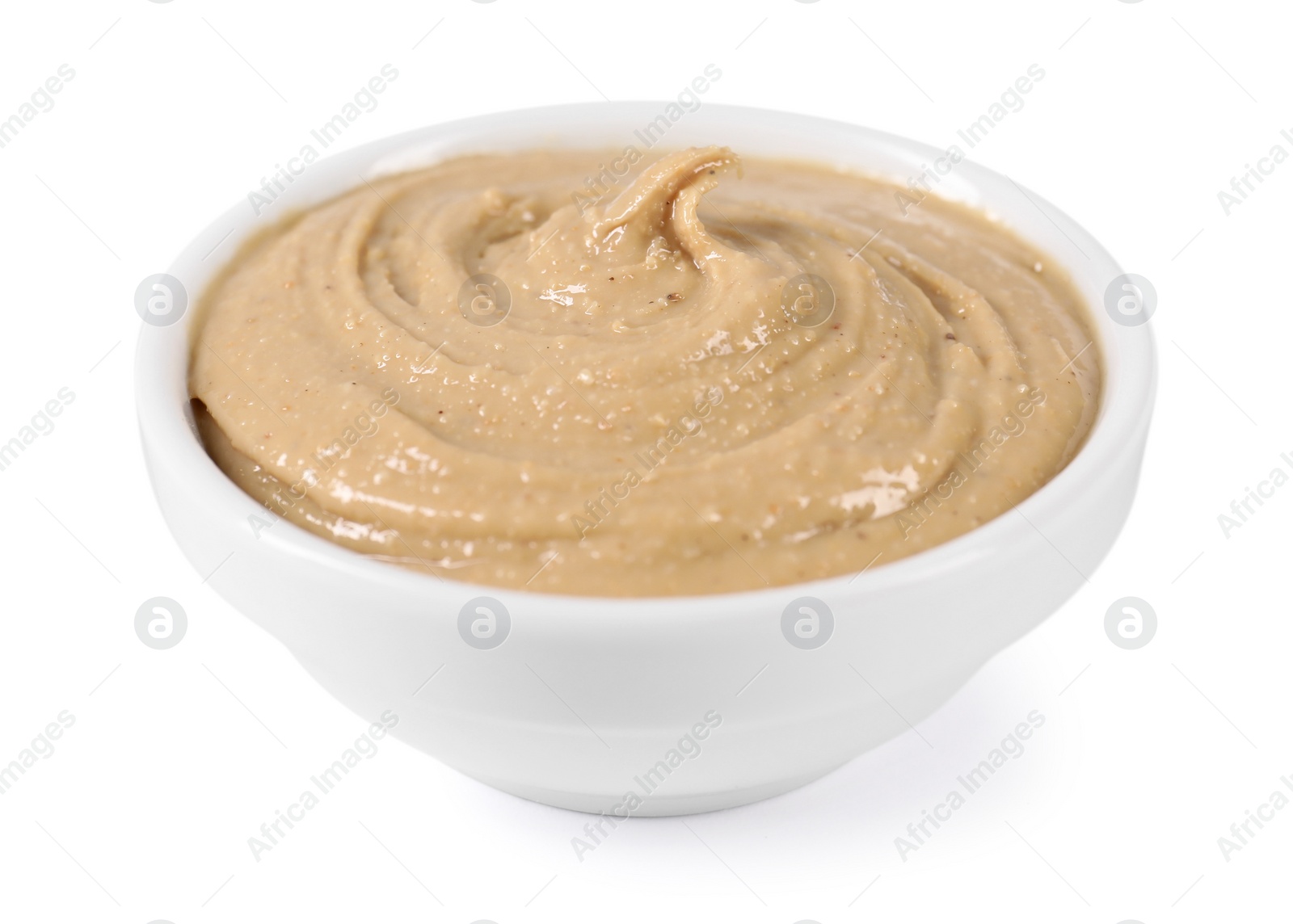 Photo of Delicious nut butter in bowl isolated on white