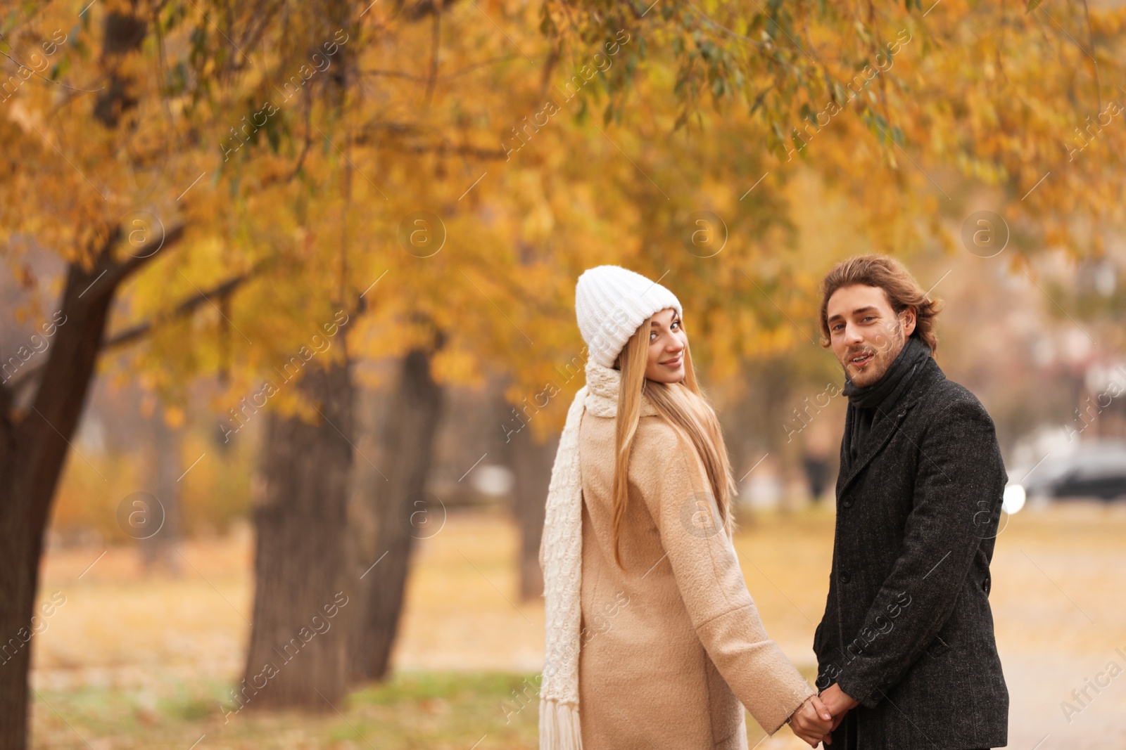 Photo of Young romantic couple in park on autumn day