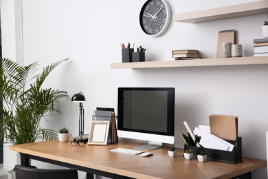 Modern computer on table in office interior. Stylish workplace