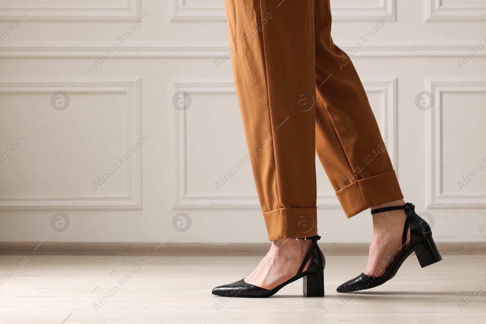 Photo of Businesswoman in elegant leather shoes indoors, closeup. Space for text