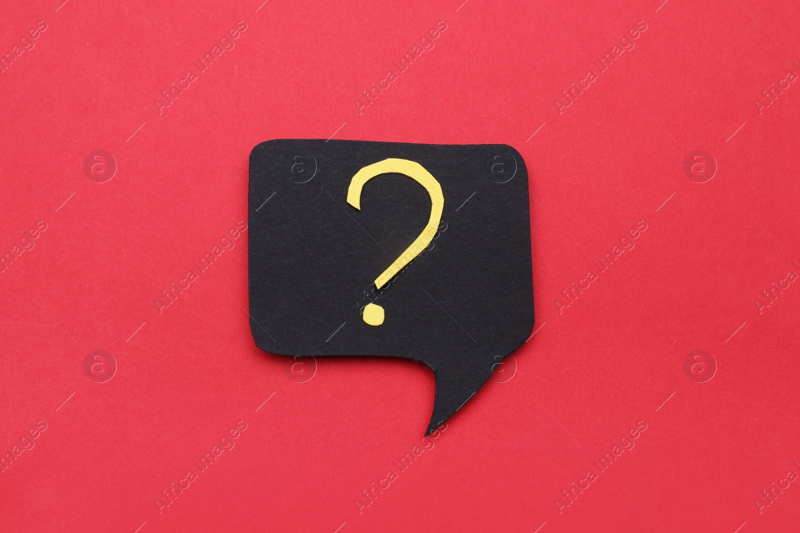 Photo of Paper speech bubble with question mark on red background, top view